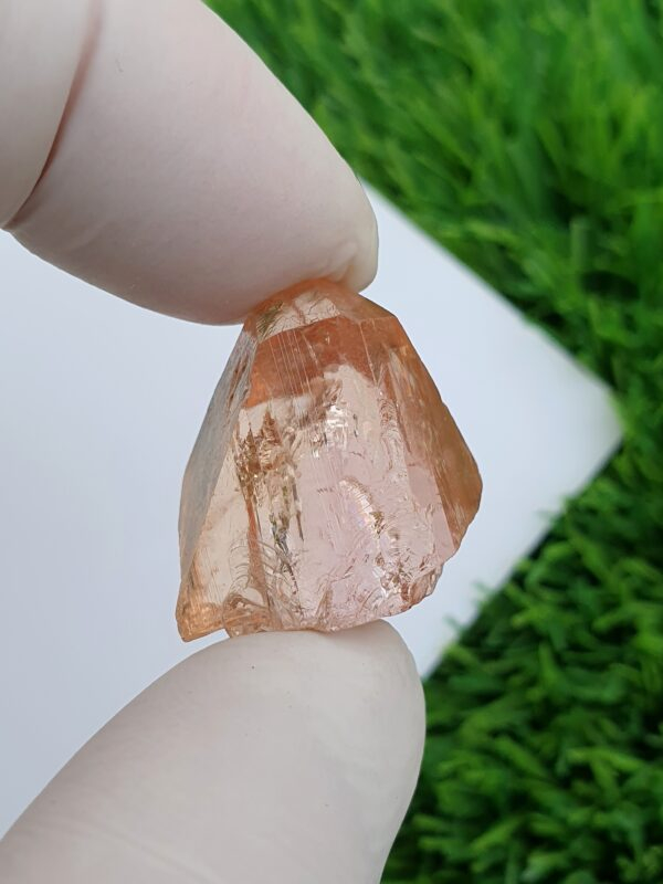 raw imperial topaz crystal from katlang. Pinkish orange