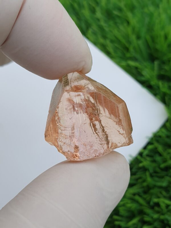 raw imperial topaz crystal from katlang. Pinkish orange