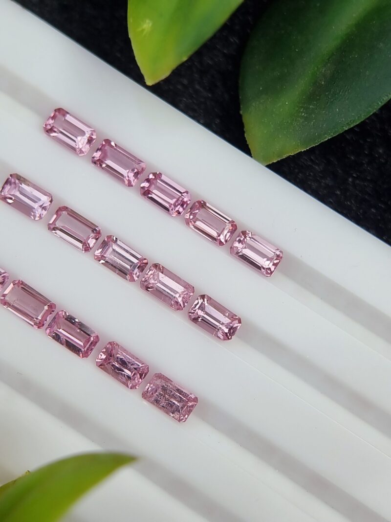 A collection of 15 natural pink spinel gemstones from Tajikistan with an emerald cut shape and a total weight of 5.07 carats.