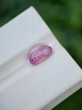 A photo of a pink sapphire from Afghanistan with oval mixed cut shape and transparent clarity on a white background | 2.62 ct | GGI certified
