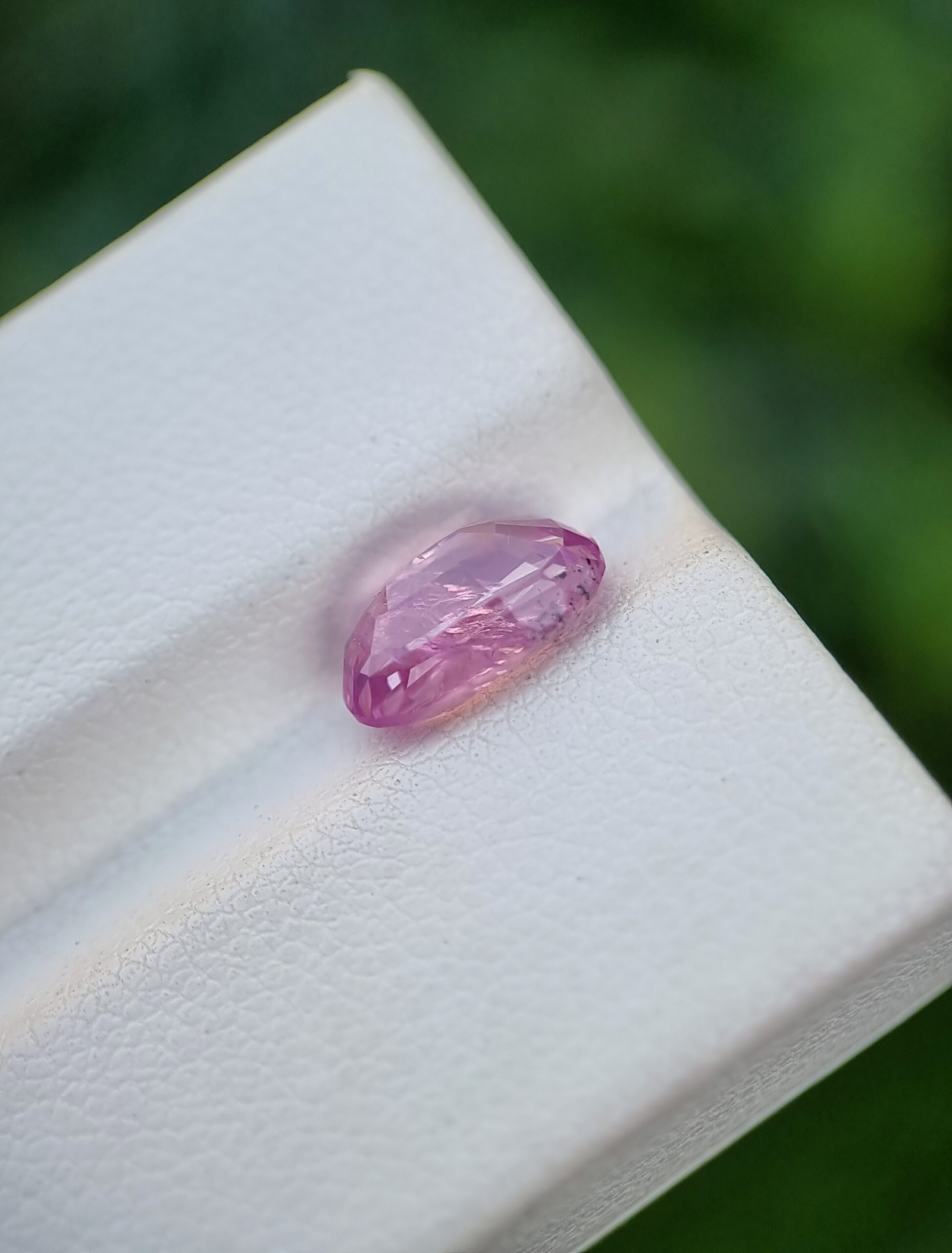 A photo of a pink sapphire from Afghanistan with oval mixed cut shape and transparent clarity on a white background | 2.62 ct | GGI certified