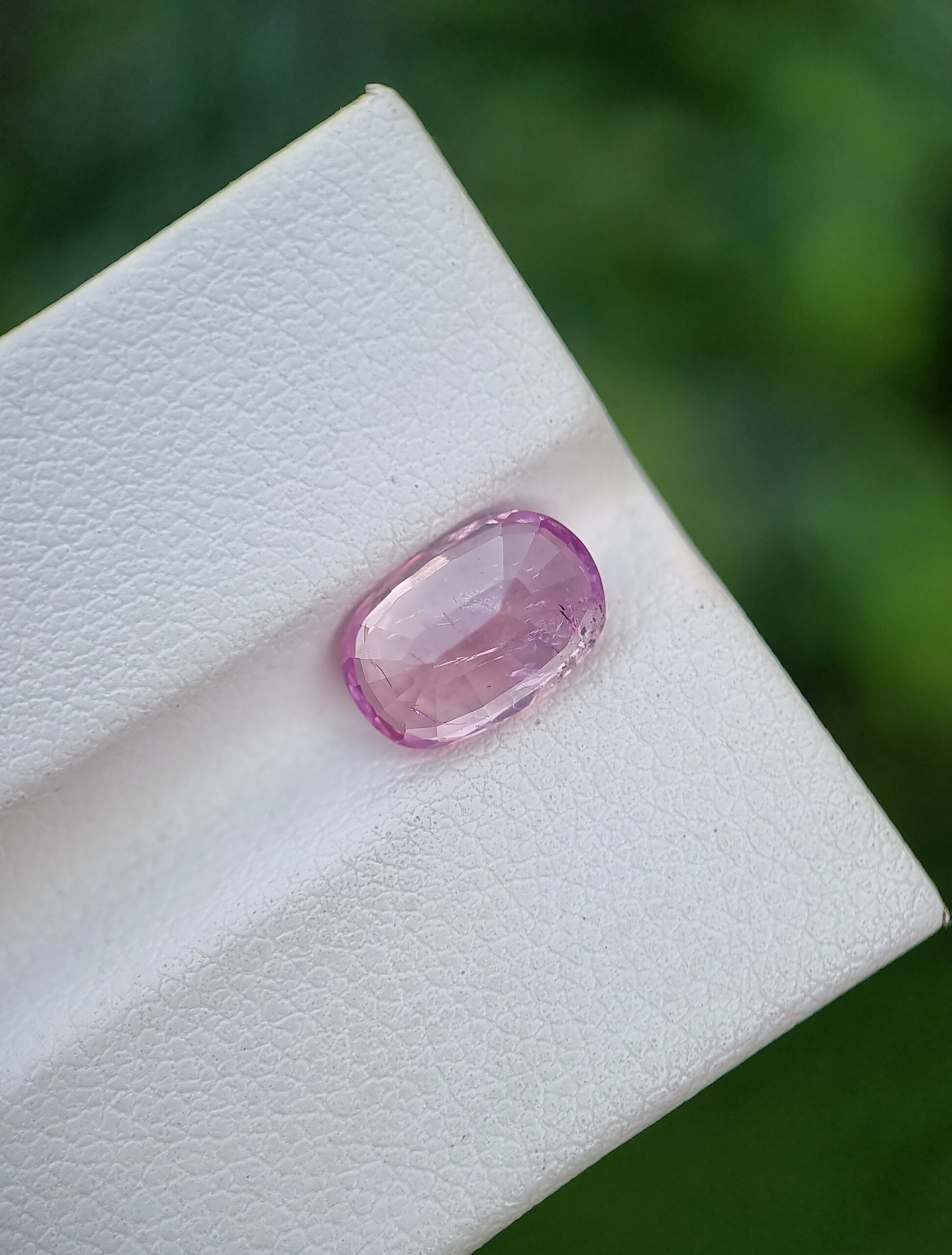 A photo of a pink sapphire from Afghanistan with oval mixed cut shape and transparent clarity on a white background | 2.62 ct | GGI certified