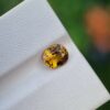 A photo of a certified Epidote gemstone with a brownish-yellow color and oval shape | Certified by Galaxy Gemological Institute | 1.05 ct