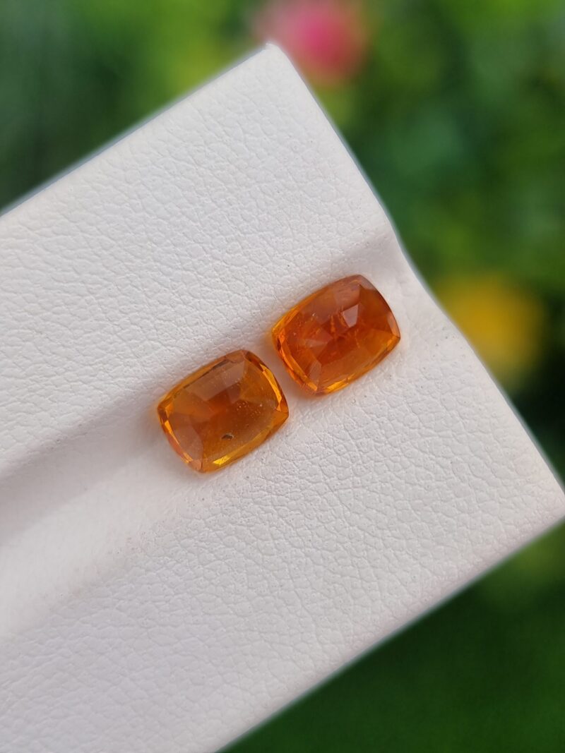 Rare Natural Clinohumite pair, cushion cut gemstones from Tajikistan with vibrant orange hues