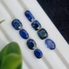 Collection of eight blue sapphires in various cuts and shades, certified by Galaxy Gemological Institute, perfect for fine jewelry.
