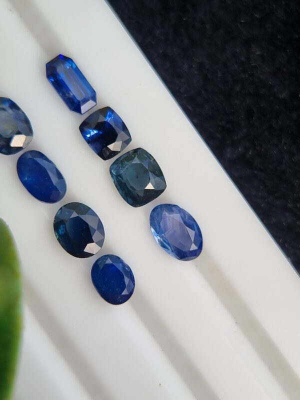 Collection of eight blue sapphires in various cuts and shades, certified by Galaxy Gemological Institute, perfect for fine jewelry.