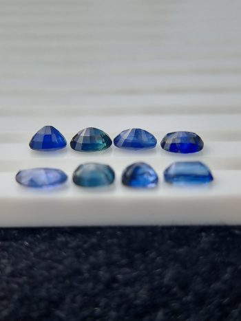 Collection of eight blue sapphires in various cuts and shades, certified by Galaxy Gemological Institute, perfect for fine jewelry.
