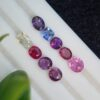 Assorted collection of nine certified natural sapphires in mixed cuts and a range of colors, totaling 5.09 carats