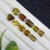 Lot of ten natural tourmalines totaling 8.57 ct, in emerald, cushion, and pear shapes, with yellowish green to orange tones, from Afghanistan, untreated.