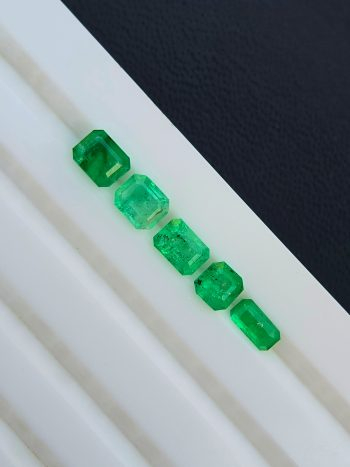 A close-up, high-resolution image of a 1.09 carat, cushion-cut natural green emerald gemstone from the Swat Valley, Pakistan, with visible inclusions.