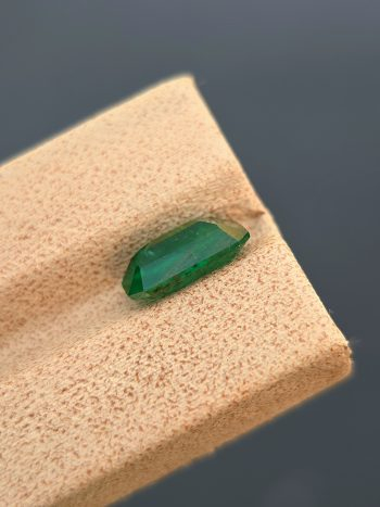 a 2.40 ct natural emerald from Swat, Pakistan. The stone has a classic emerald cut and a green color with visible inclusions.