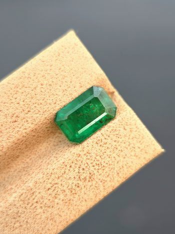 a 2.40 ct natural emerald from Swat, Pakistan. The stone has a classic emerald cut and a green color with visible inclusions.