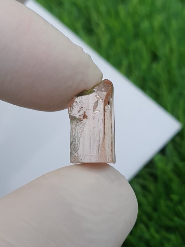 raw imperial topaz crystal from katlang. Pinkish orange