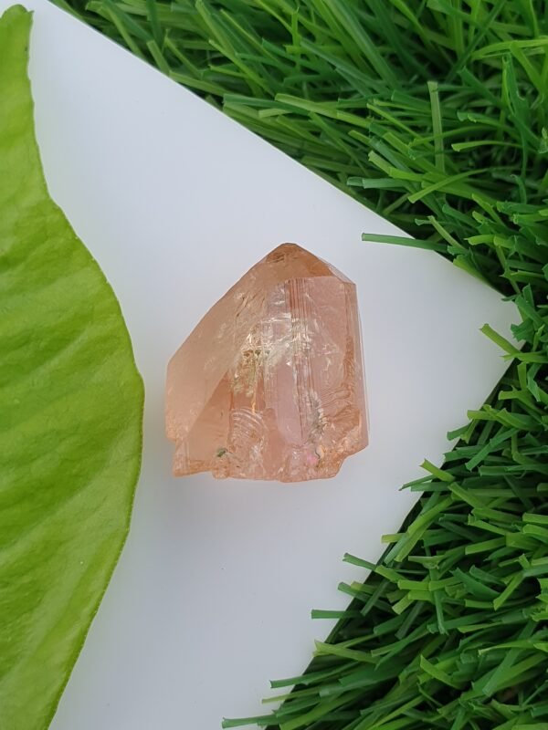 raw imperial topaz crystal from katlang. Pinkish orange