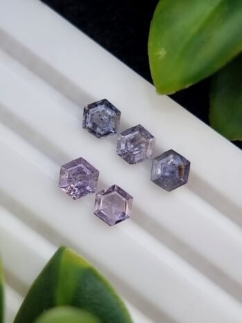 Five hexagonal natural spinel stones in varying shades of purple and violet, untreated and calibrated, from Badakhshan, Afghanistan
