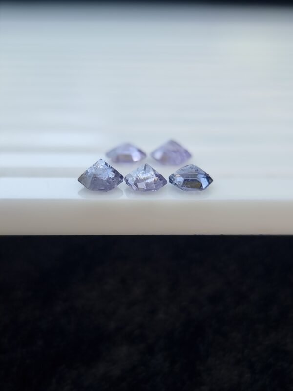 Five hexagonal natural spinel stones in varying shades of purple and violet, untreated and calibrated, from Badakhshan, Afghanistan