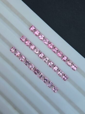 A group of 30 calibrated natural pink spinel gemstones with a square shape, displayed together. The gems are from Tajikistan and have an average weight of 0.18 ct.